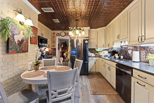 a kitchen with stainless steel appliances kitchen island granite countertop a sink and cabinets