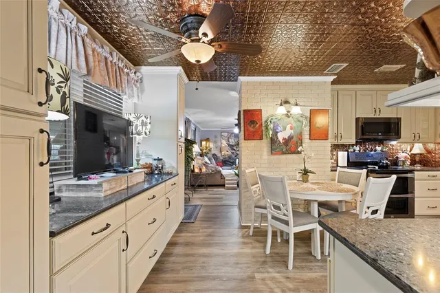 a large kitchen with a table and chairs