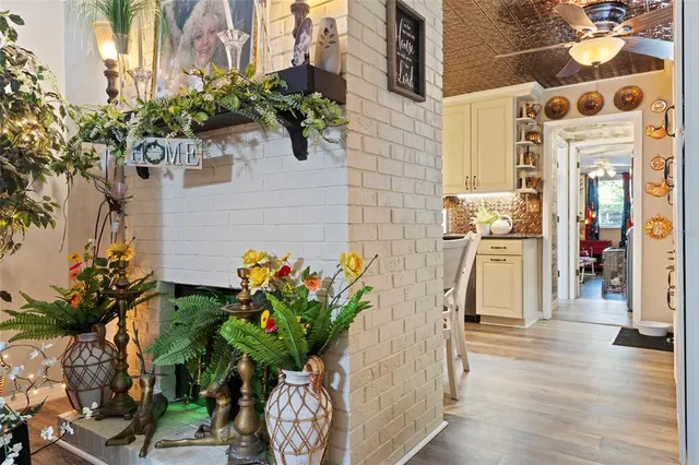 a vase of flowers sitting on a wooden floor