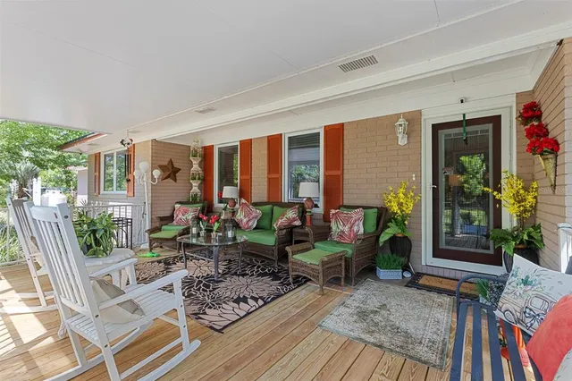 a view of a house with backyard and sitting area