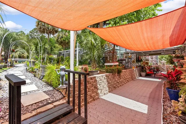 a view of a patio with a table and chairs under an umbrella