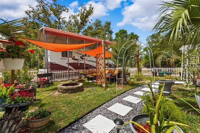 an aerial view of a house with garden space and street view