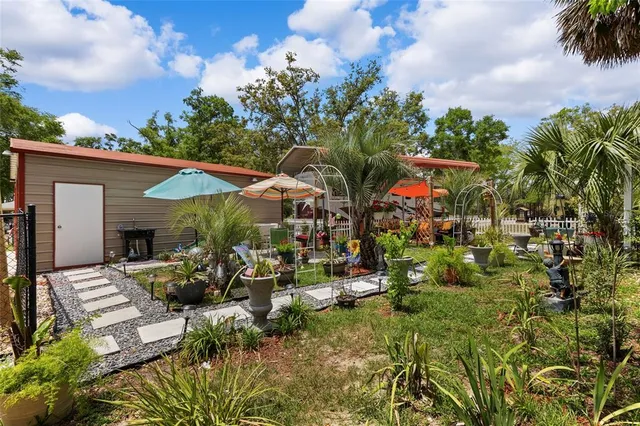 an aerial view of residential houses with outdoor space and street view