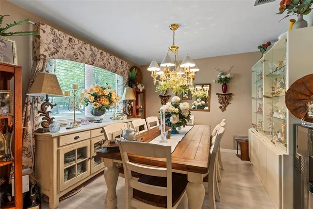 a view of a dining room with furniture and chandelier