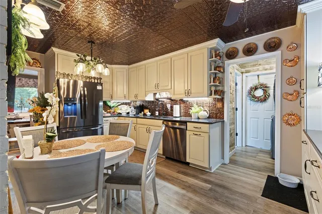 a kitchen with stainless steel appliances kitchen island granite countertop a refrigerator and a stove