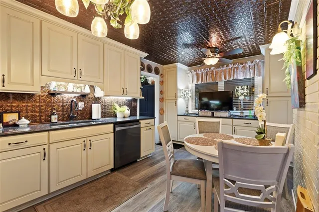 a kitchen with stainless steel appliances granite countertop a sink and cabinets