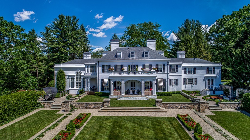1075 Lowell Road Concord, MA 01742 - Photo 1 of 26 a front view of a house with a yard table and chairs