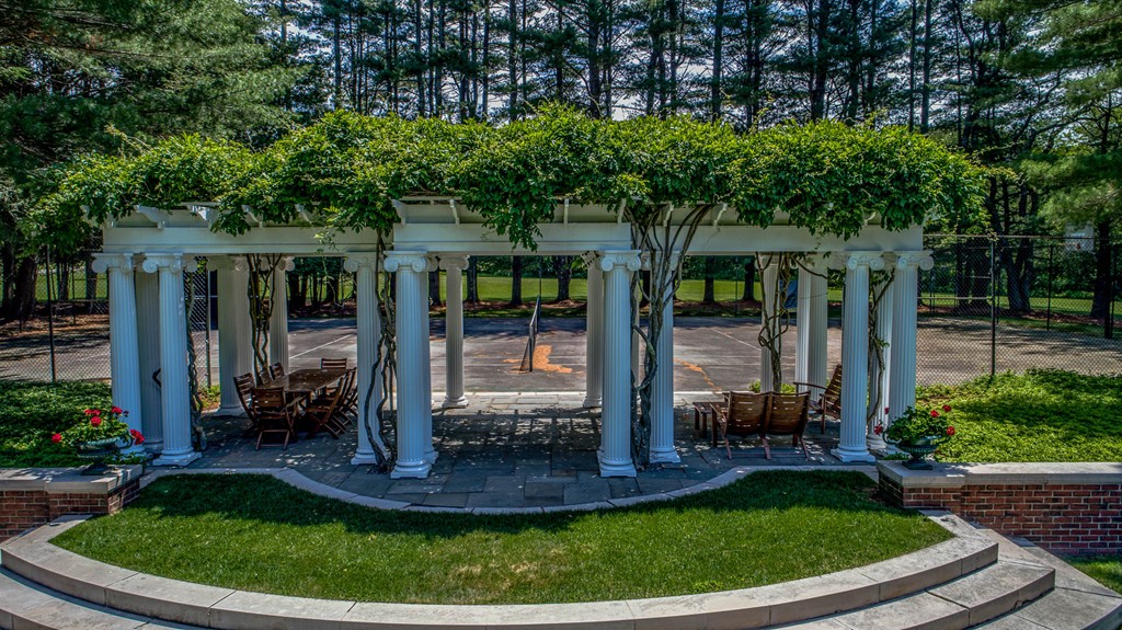 1075 Lowell Road Concord, MA 01742 - Photo 14 of 26 a view of a house with a backyard porch and sitting area