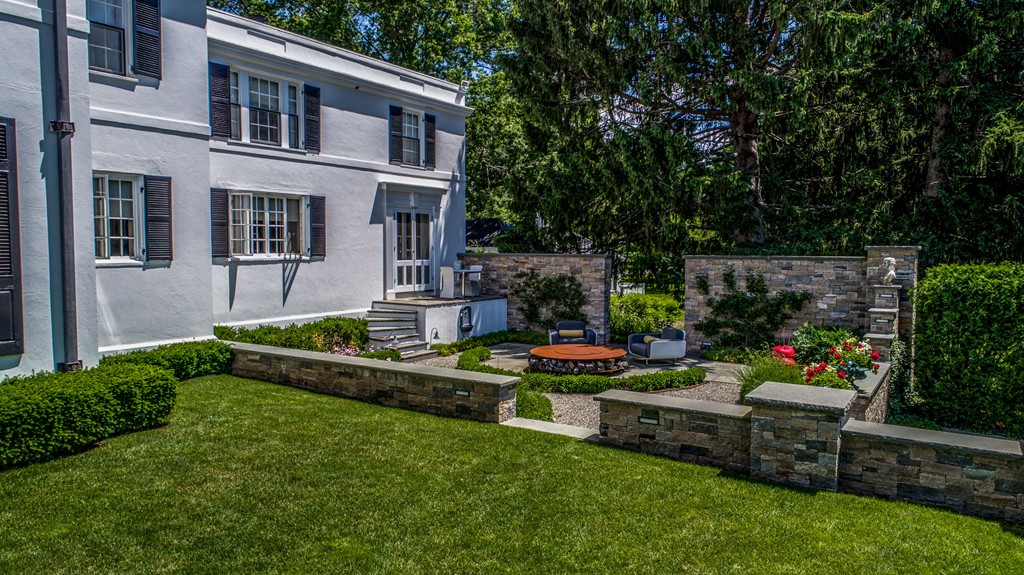 1075 Lowell Road Concord, MA 01742 - Photo 16 of 26 a front view of a house with a yard table and chairs