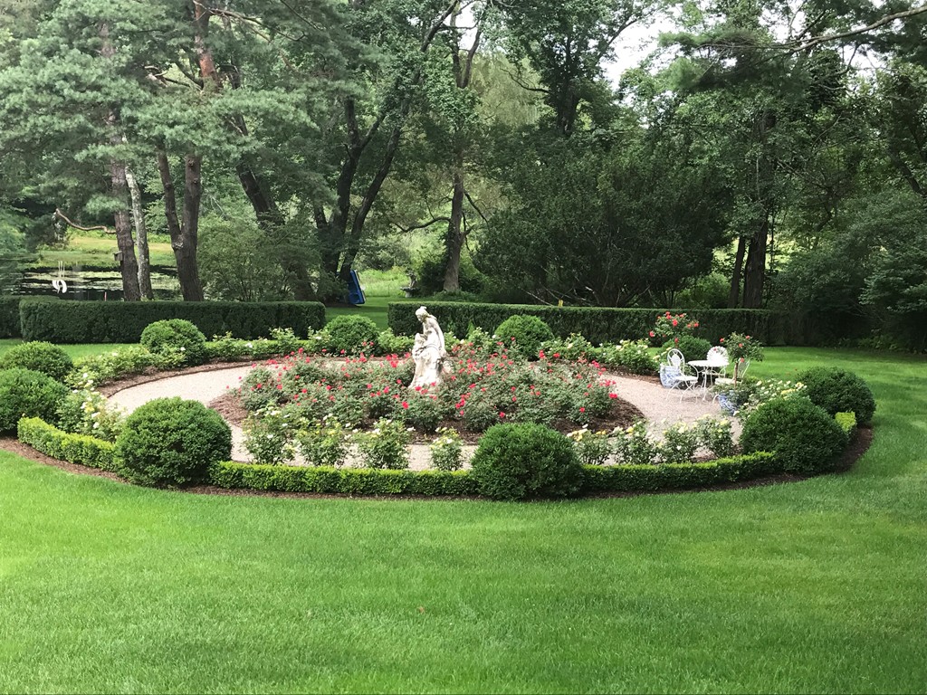 1075 Lowell Road Concord, MA 01742 - Photo 20 of 26 a view of a garden with a fountain