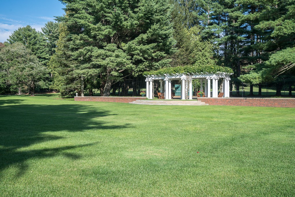 1075 Lowell Road Concord, MA 01742 - Photo 25 of 26 a front view of a house with a yard