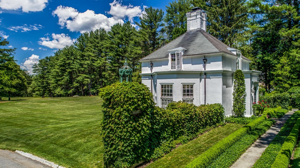 1075 Lowell Road Concord, MA 01742 - Photo 4 of 26 a front view of a house with garden