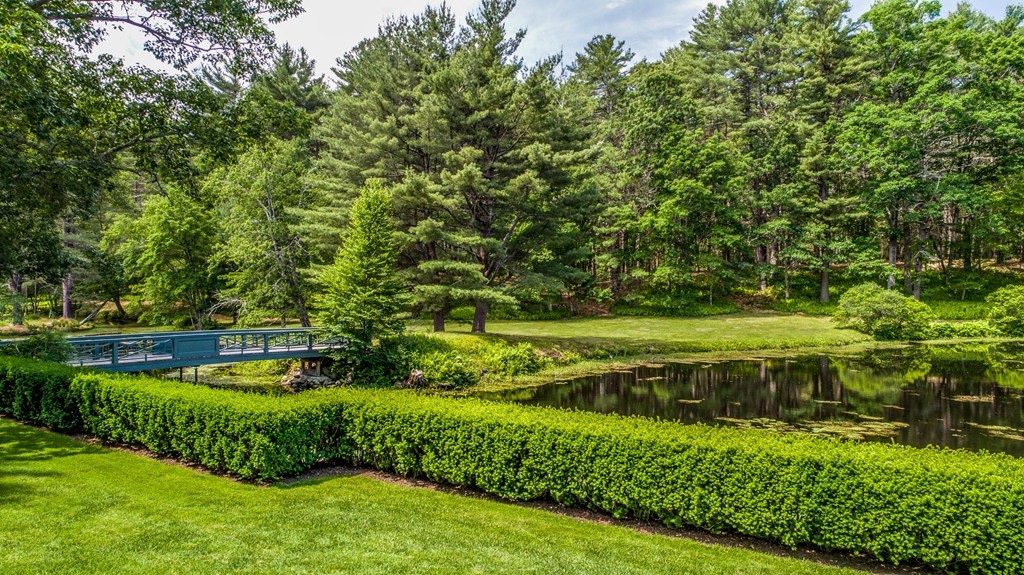 1075 Lowell Road Concord, MA 01742 - Photo 8 of 26 a view of a garden with large trees