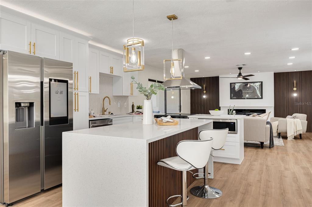 2034 58th Way North Clearwater, FL 33760 - Photo 11 of 35 a kitchen with cabinets a sink stainless steel appliances and wooden floor