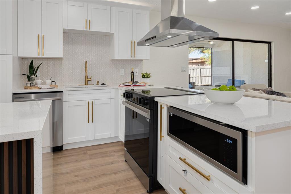 2034 58th Way North Clearwater, FL 33760 - Photo 12 of 35 a kitchen with a stove and a sink