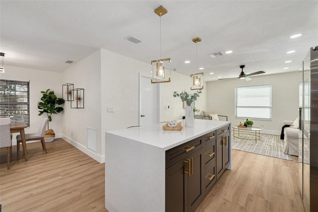 2034 58th Way North Clearwater, FL 33760 - Photo 13 of 35 a large kitchen with kitchen island a sink a counter space and stainless steel appliances