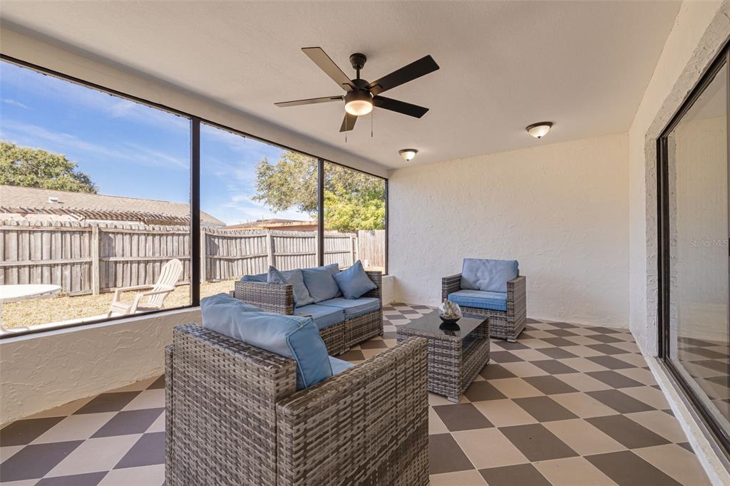 2034 58th Way North Clearwater, FL 33760 - Photo 16 of 35 a living room with furniture and a large window with garden view