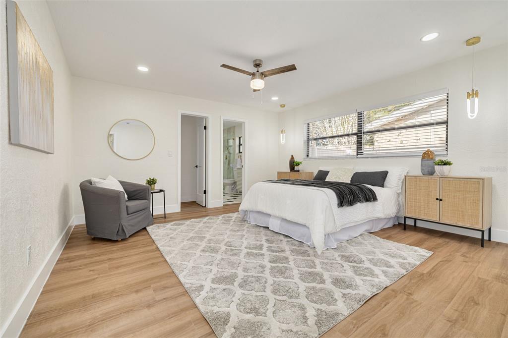 2034 58th Way North Clearwater, FL 33760 - Photo 18 of 35 a bedroom with a large bed and a chandelier