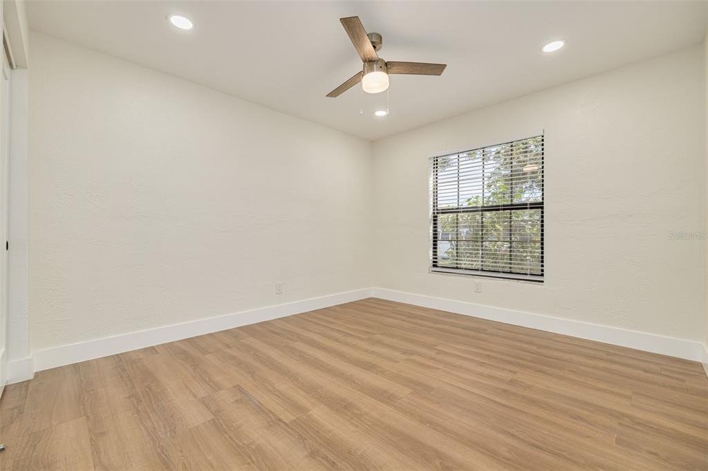 2034 58th Way North Clearwater, FL 33760 - Photo 24 of 35 an empty room with wooden floor and windows