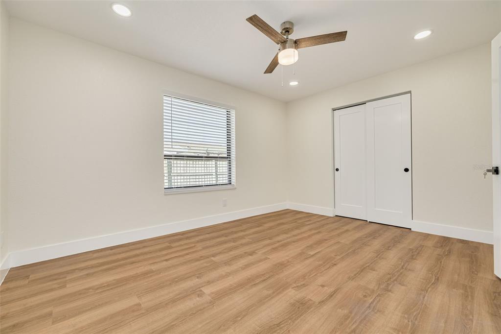 2034 58th Way North Clearwater, FL 33760 - Photo 30 of 35 a view of an empty room with wooden floor and a window