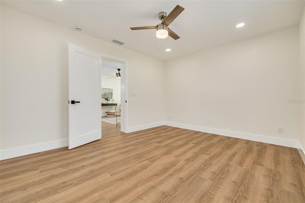 2034 58th Way North Clearwater, FL 33760 - Photo 31 of 35 an empty room with wooden floor and windows