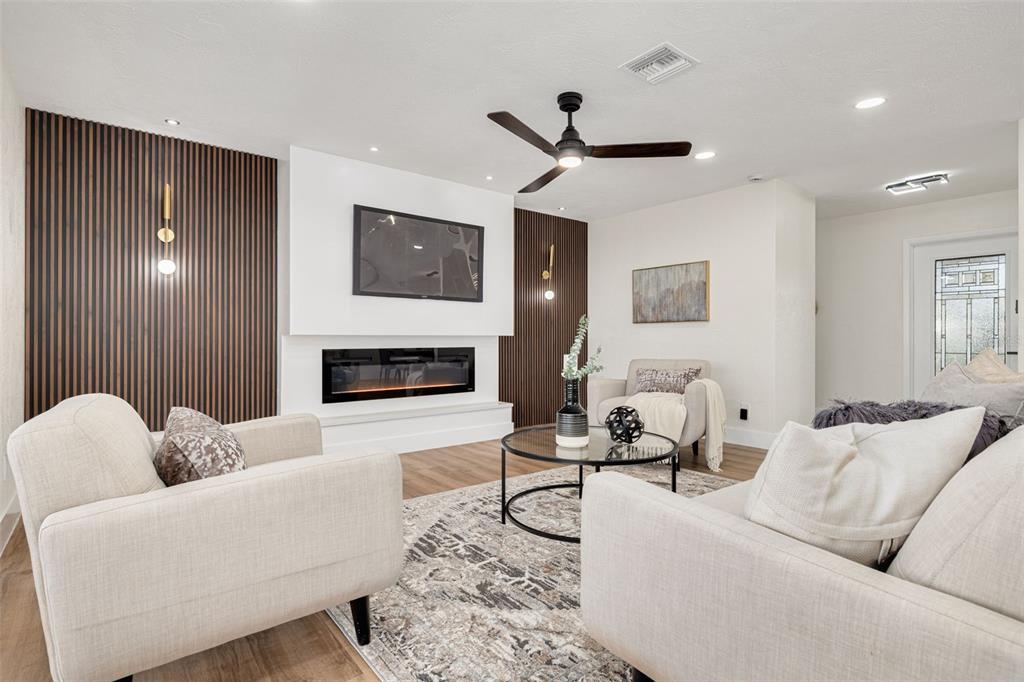 2034 58th Way North Clearwater, FL 33760 - Photo 9 of 35 a living room with furniture and a fireplace