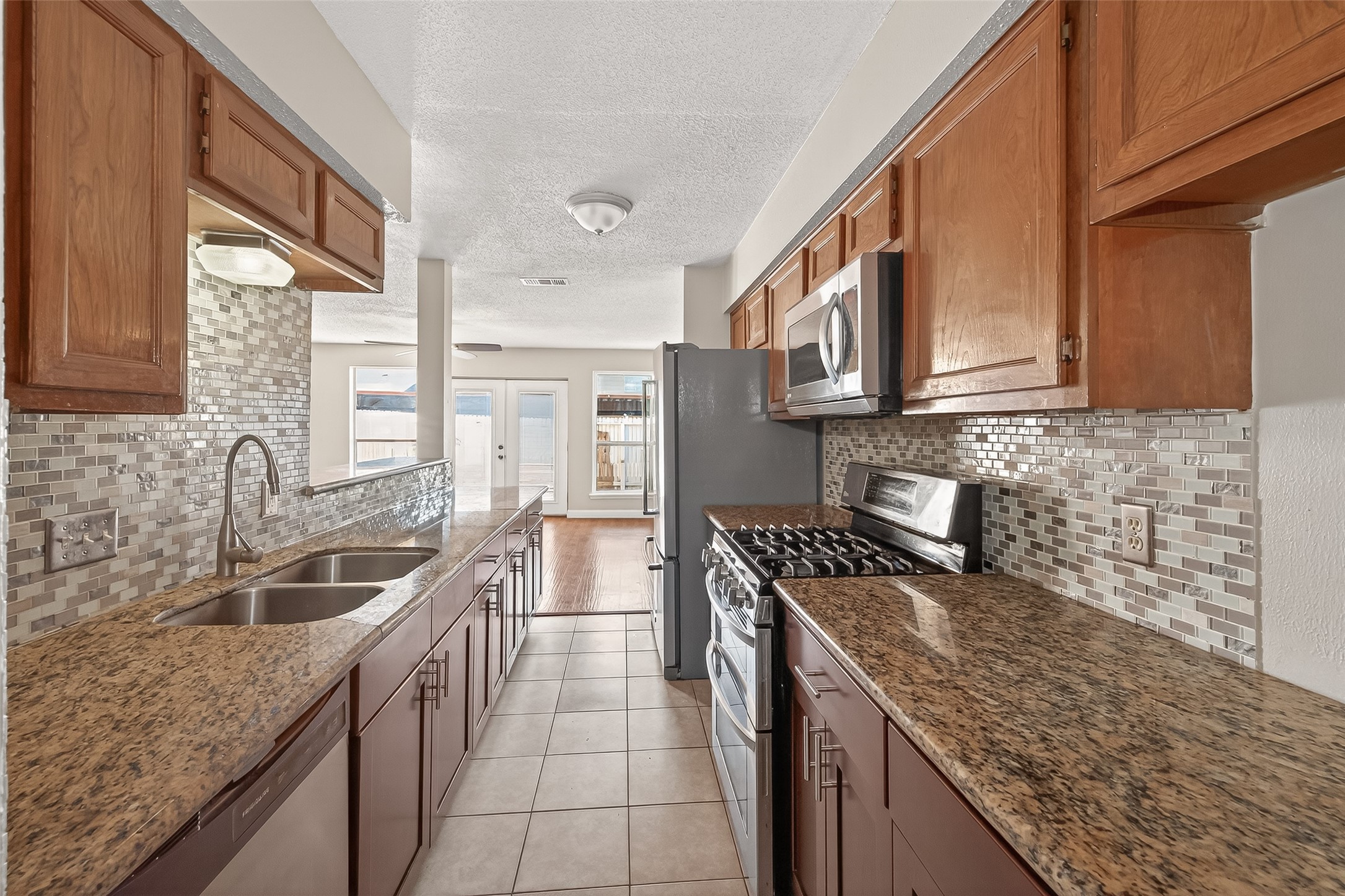 6424 Kentwick Drive, Unit 24/3 Houston, TX 77084 - Photo 1 of 48 a kitchen that has a sink and a stove