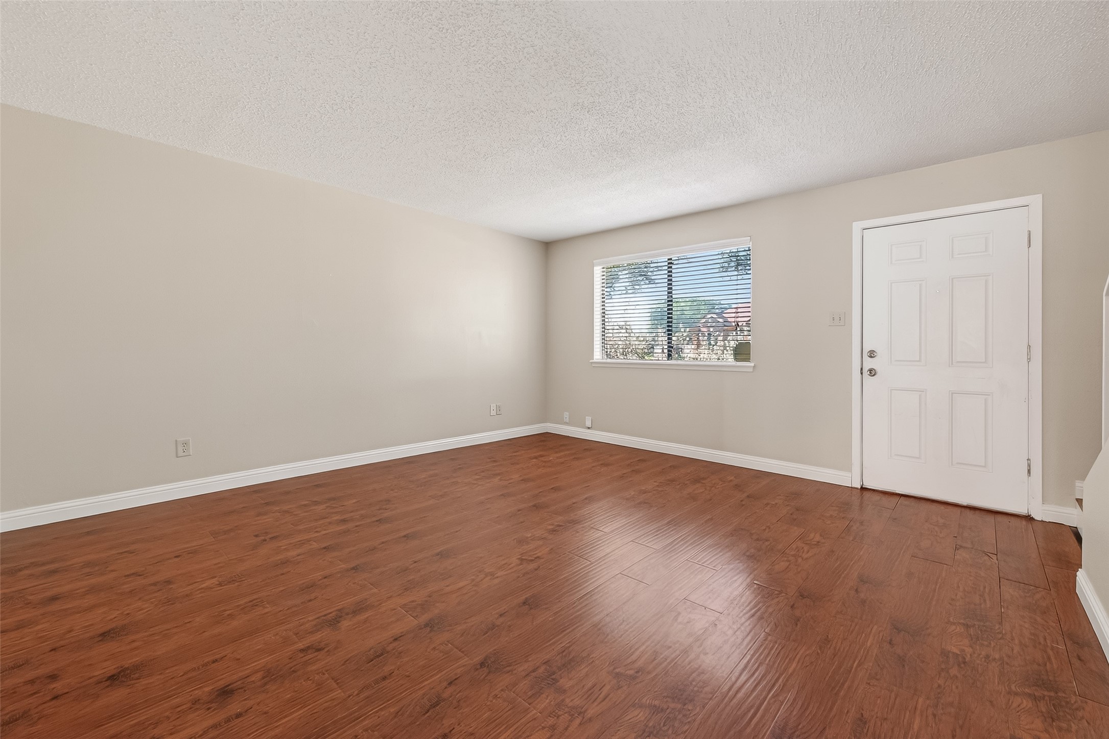 6424 Kentwick Drive, Unit 24/3 Houston, TX 77084 - Photo 11 of 48 a view of an empty room with wooden floor and a window