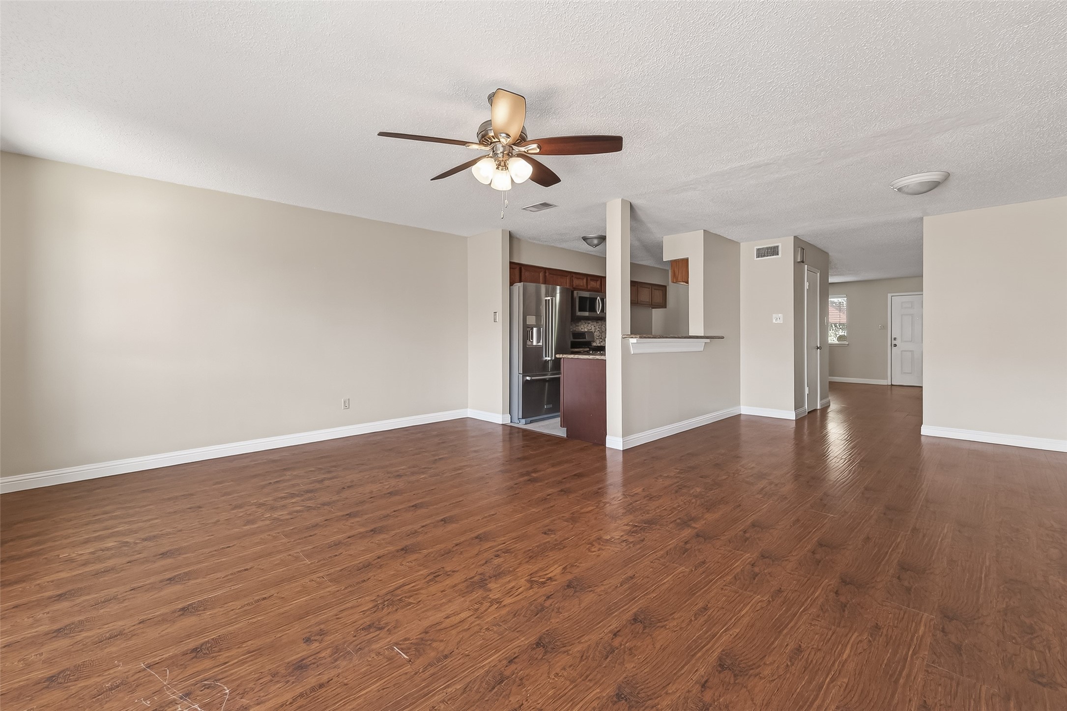 6424 Kentwick Drive, Unit 24/3 Houston, TX 77084 - Photo 18 of 48 a view of empty room with wooden floor and ceiling fan
