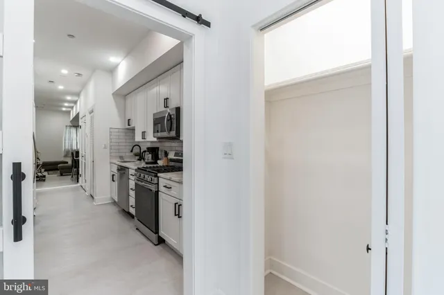 a view of a kitchen with a refrigerator