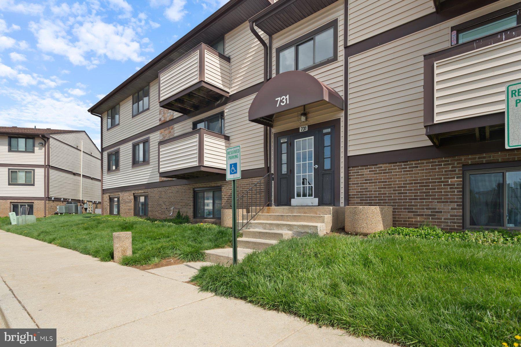 a view of a house with a yard and pathway
