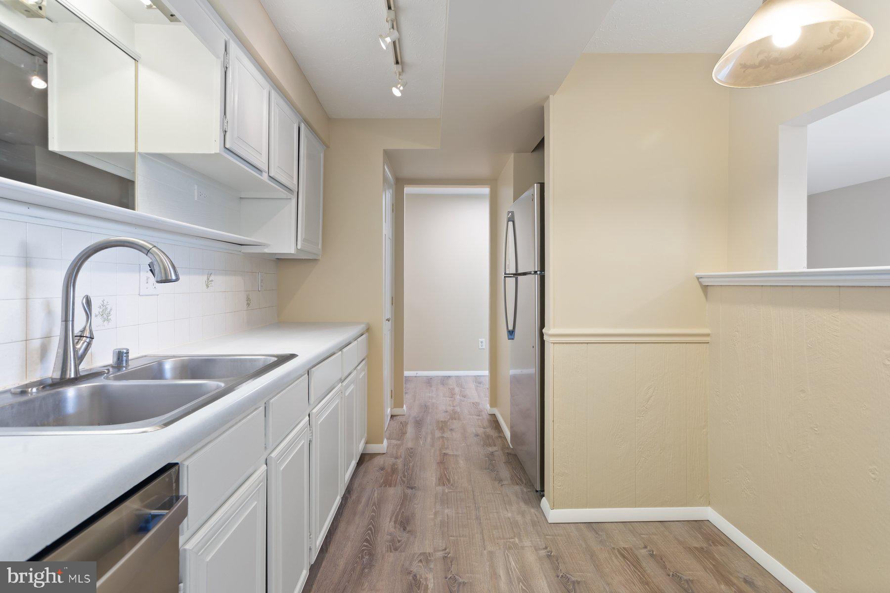 731 Heather Ridge Drive Frederick, MD 21702 - Photo 11 of 26 a kitchen with stainless steel appliances granite countertop a sink and a refrigerator