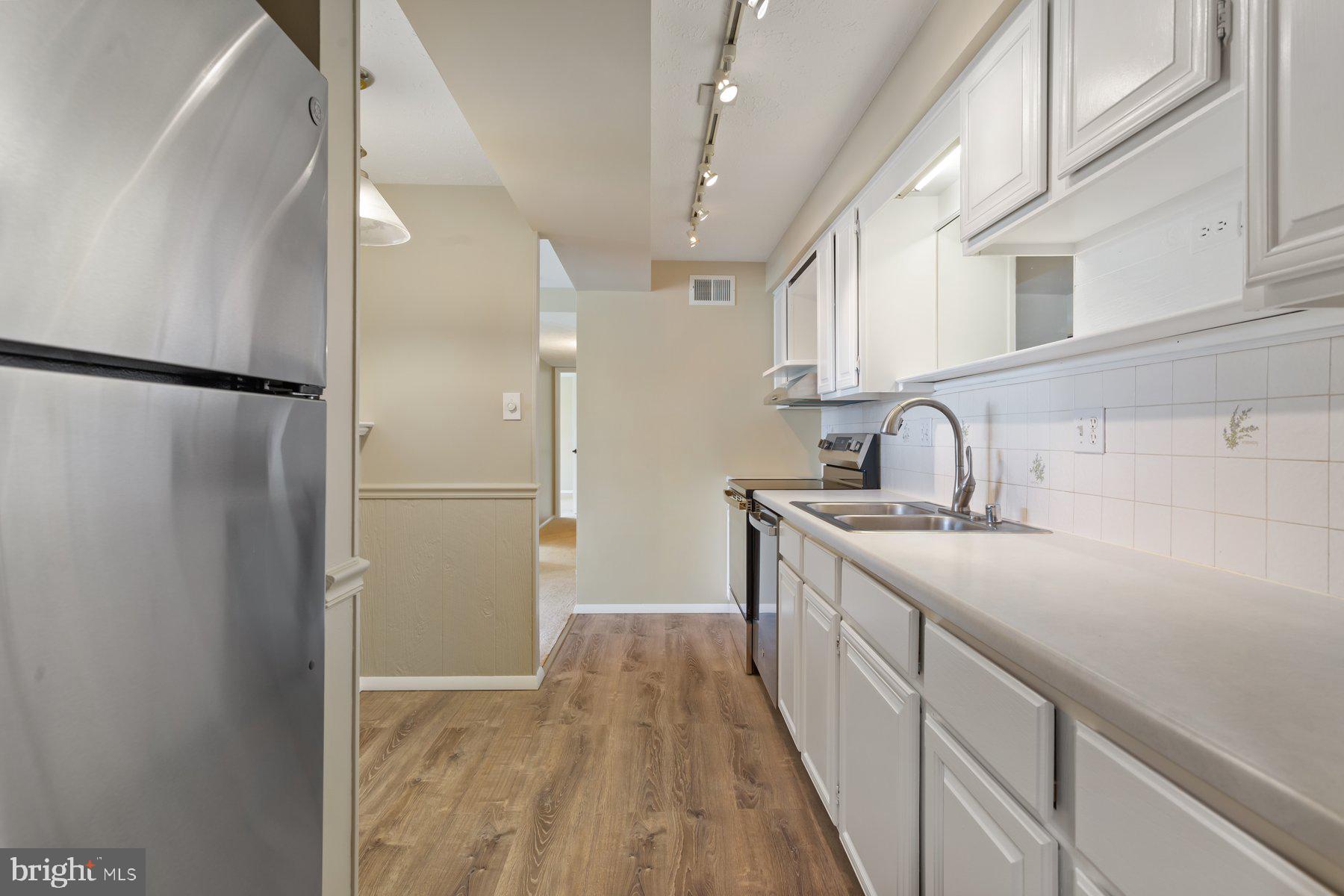 731 Heather Ridge Drive Frederick, MD 21702 - Photo 12 of 26 a kitchen with a sink and refrigerator