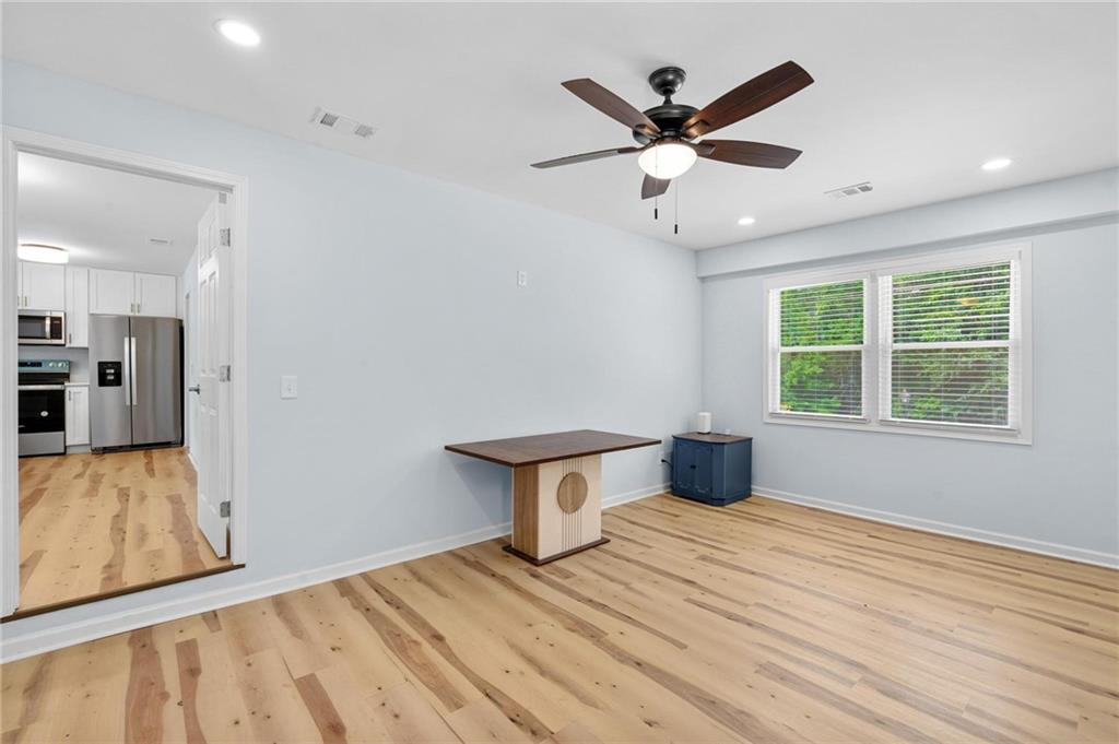 1745 Rockbridge Road Northwest Conyers, GA 30012 - Photo 20 of 32 a view of an empty room with wooden floor and a window