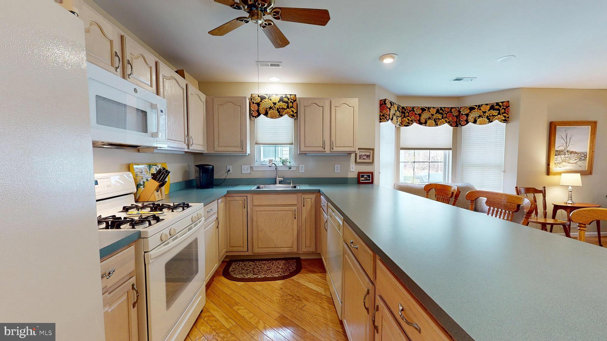 15 Carriage Berlin, NJ 08009 - Photo 18 of 61 a kitchen with stainless steel appliances granite countertop a sink a stove cabinets counter space and a window