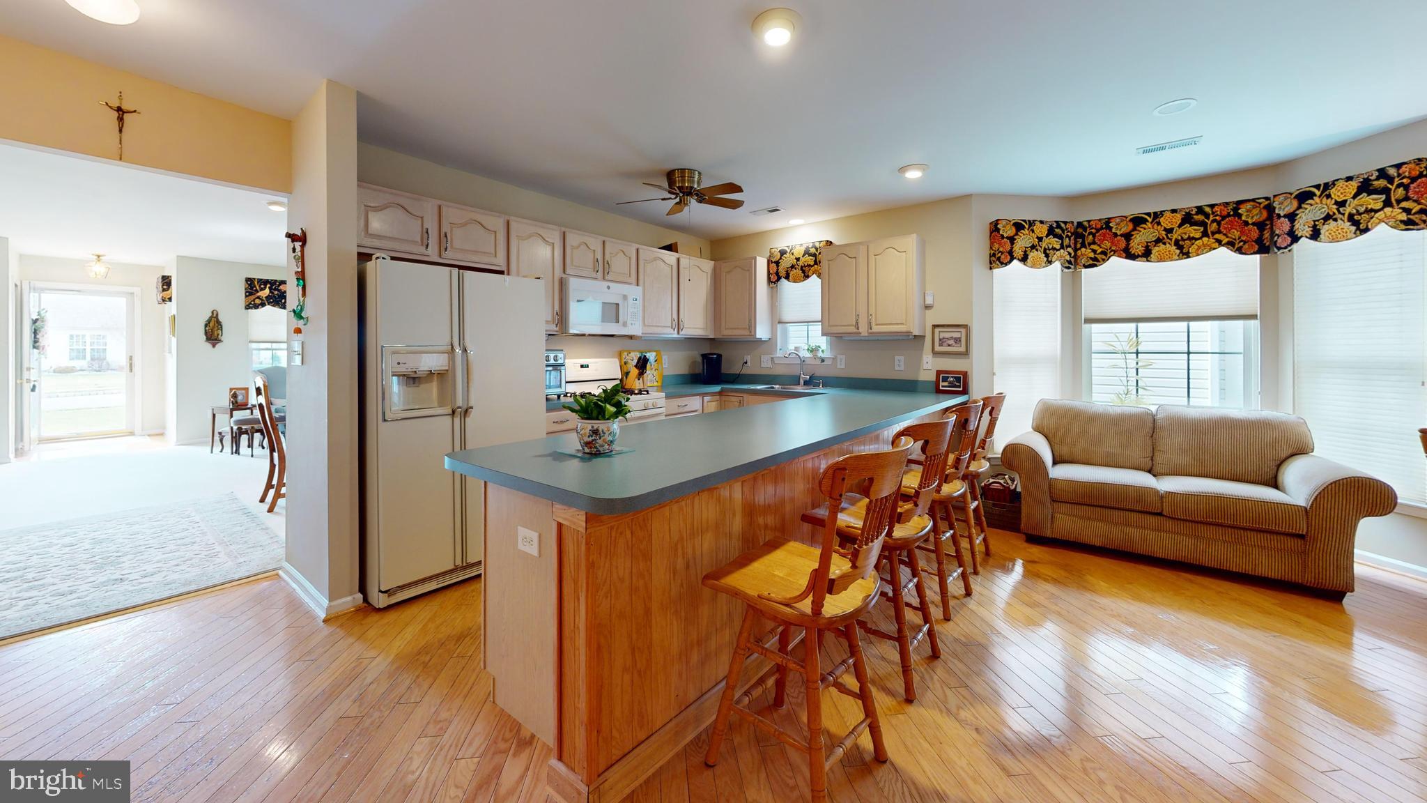 15 Carriage Berlin, NJ 08009 - Photo 23 of 61 a kitchen with stainless steel appliances granite countertop a refrigerator a sink dishwasher a stove and white cabinets with wooden floor