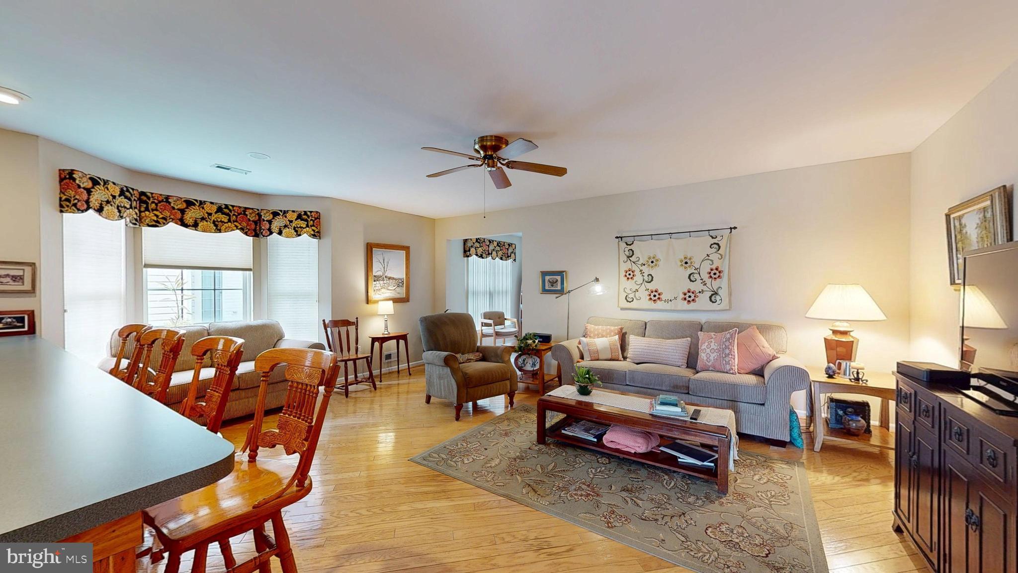 15 Carriage Berlin, NJ 08009 - Photo 24 of 61 a living room with furniture a ceiling fan and a window