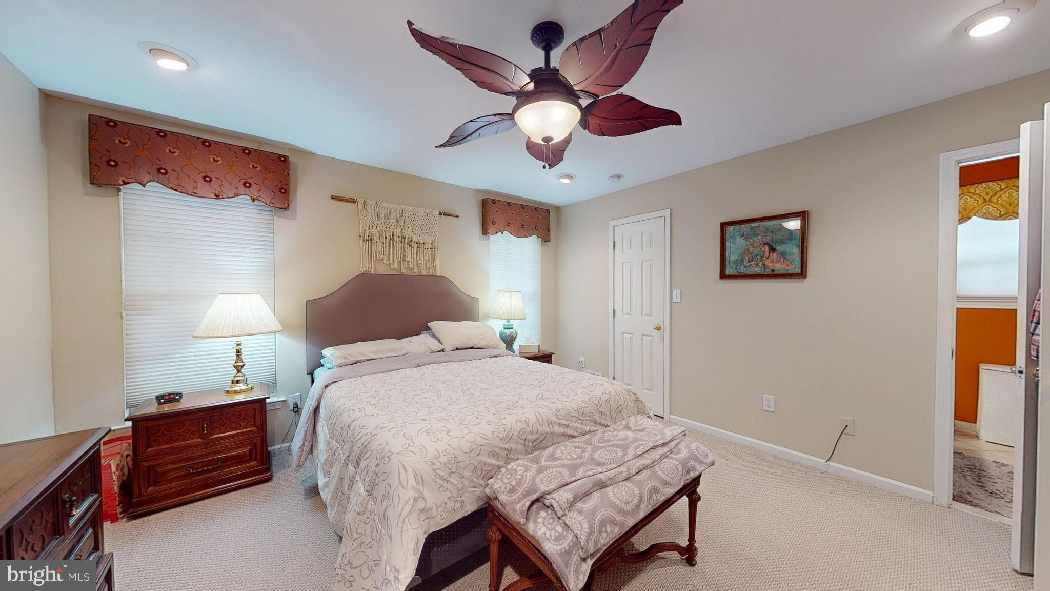 15 Carriage Berlin, NJ 08009 - Photo 41 of 61 a bedroom with a bed and a chandelier