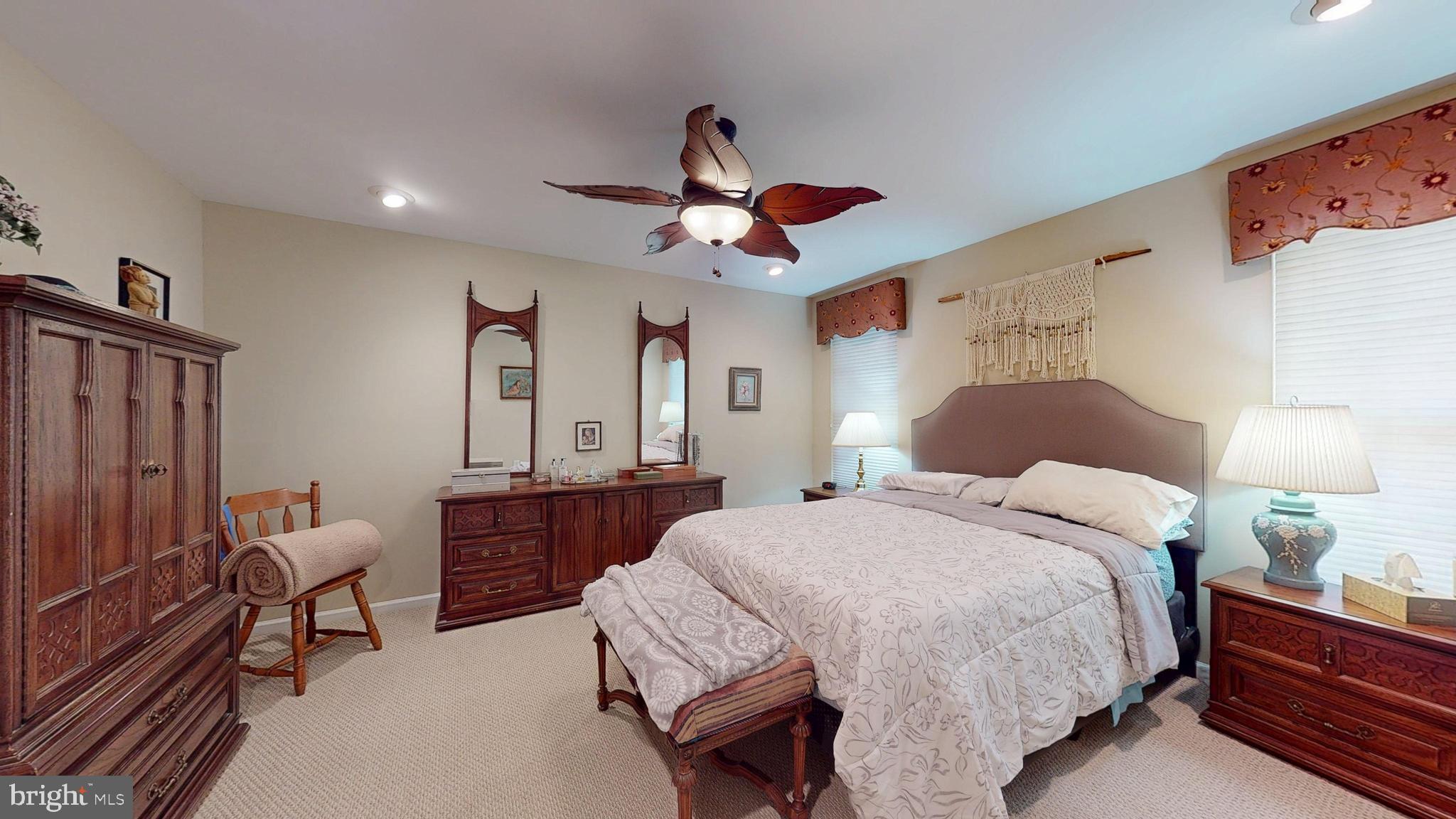 15 Carriage Berlin, NJ 08009 - Photo 43 of 61 a spacious bedroom with a bed and a chandelier