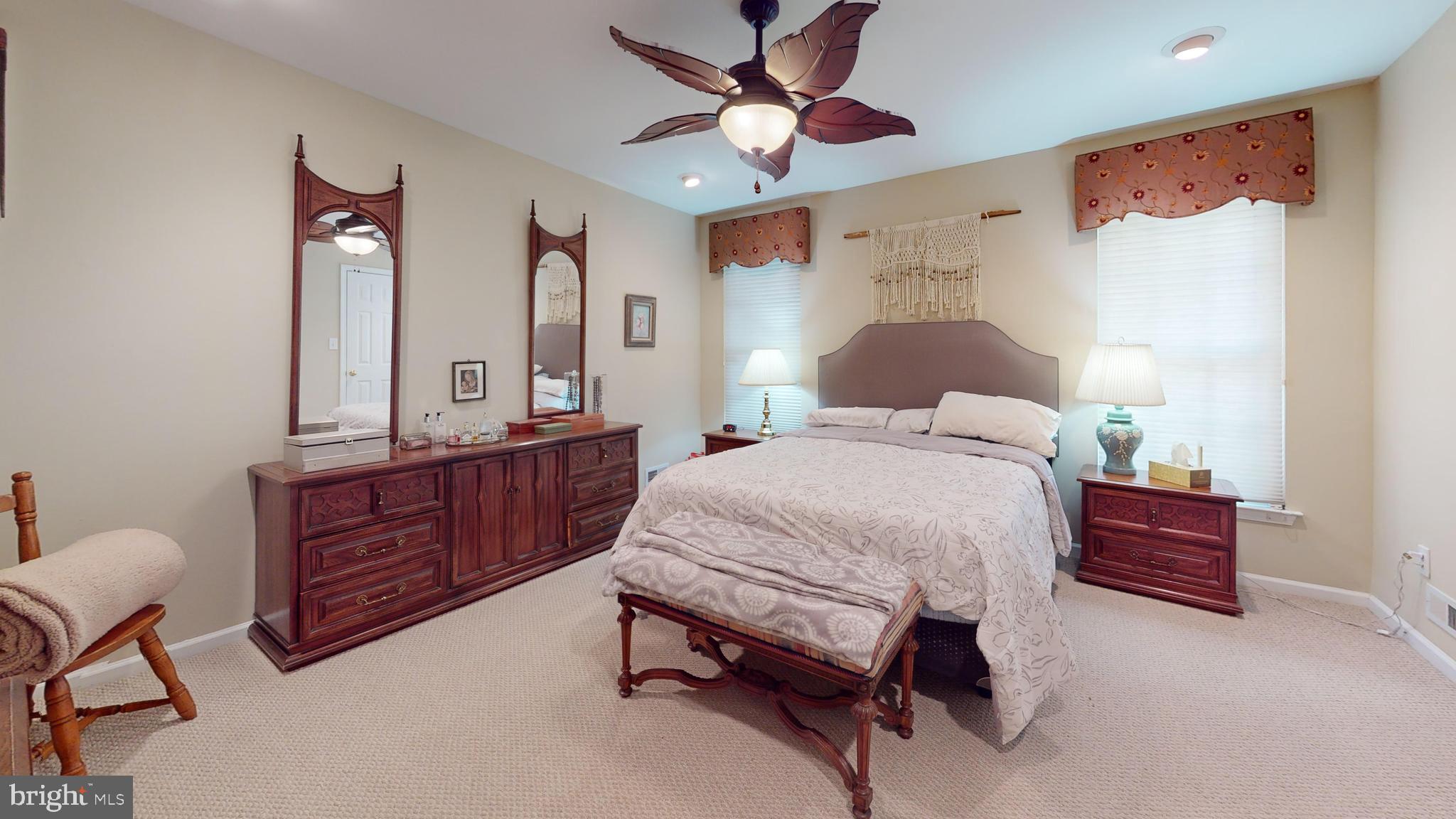 15 Carriage Berlin, NJ 08009 - Photo 44 of 61 a bedroom with a bed and dresser with mirror