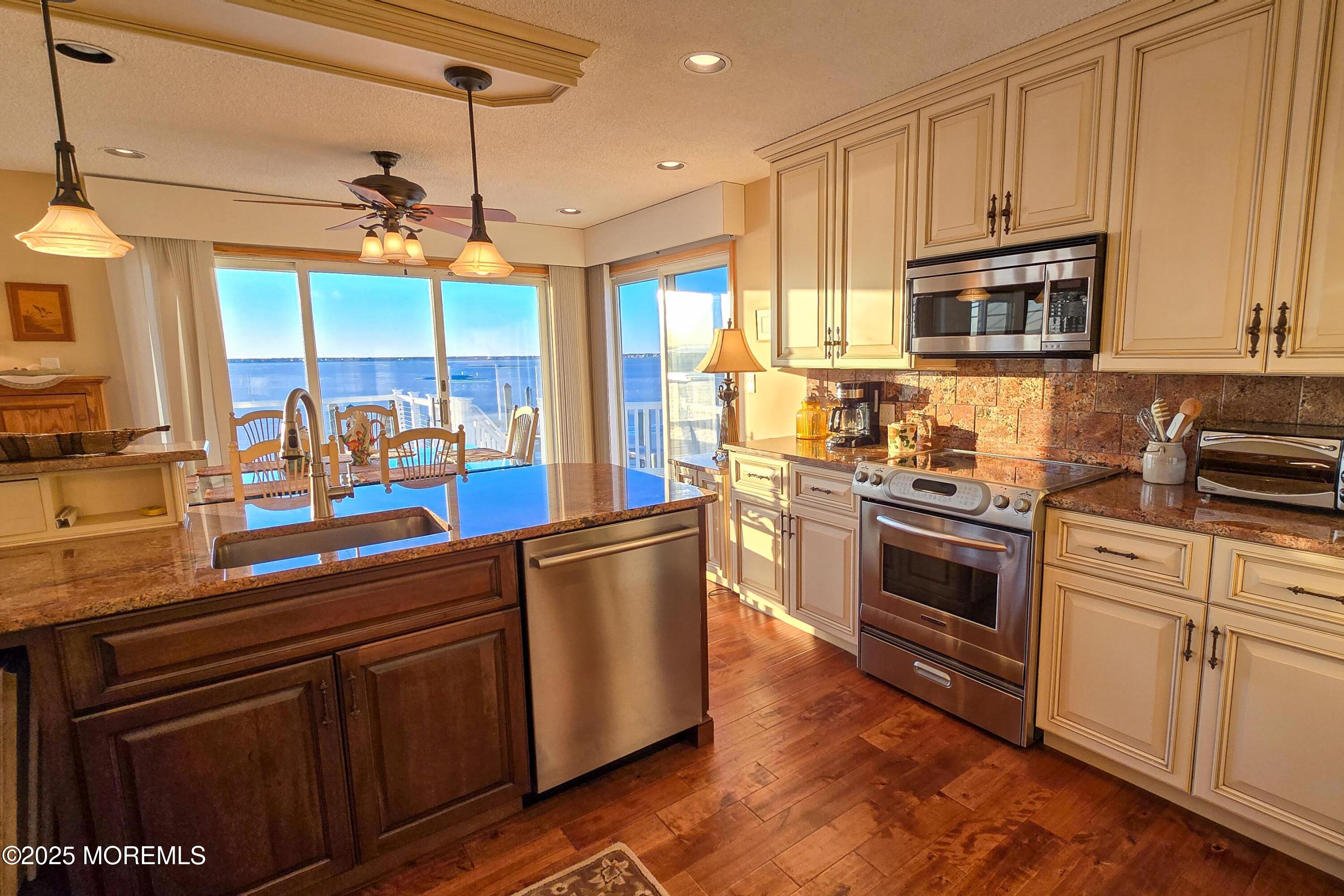 495 Boca Raton Drive Lavallette, NJ 08735 - Photo 20 of 48 a kitchen with stainless steel appliances granite countertop a sink a stove and a refrigerator