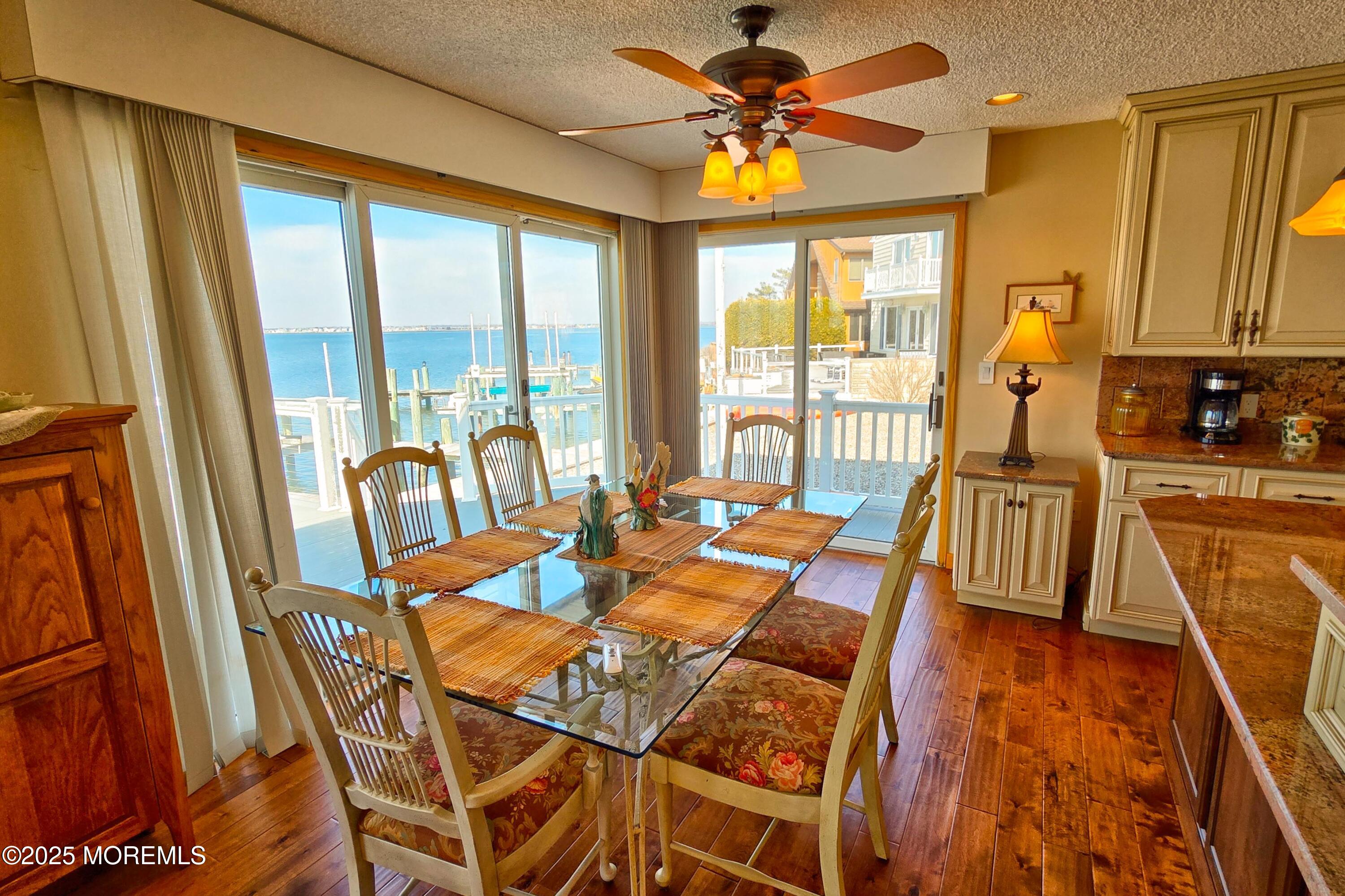 495 Boca Raton Drive Lavallette, NJ 08735 - Photo 22 of 48 a dining room with furniture a chandelier and wooden floor