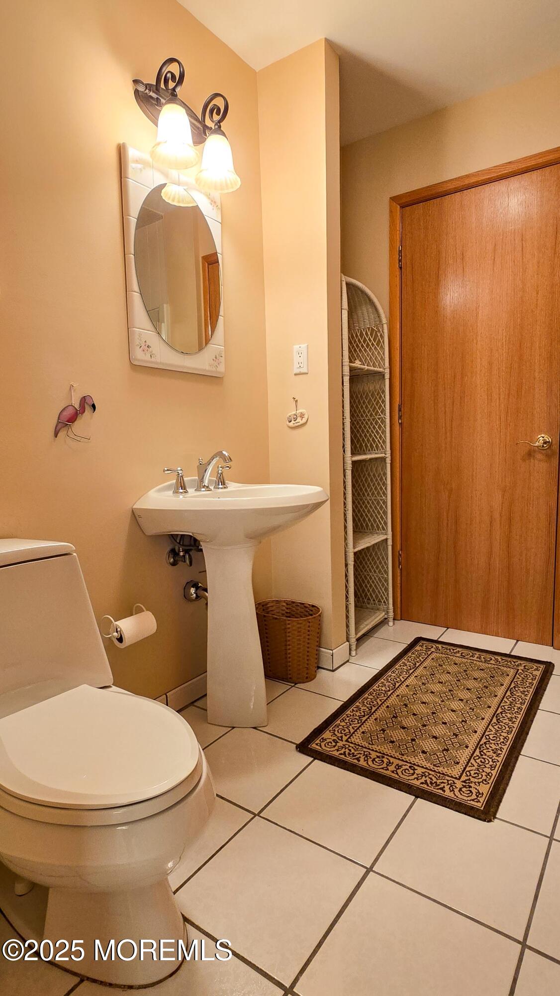 495 Boca Raton Drive Lavallette, NJ 08735 - Photo 25 of 48 a bathroom with a toilet a sink and mirror