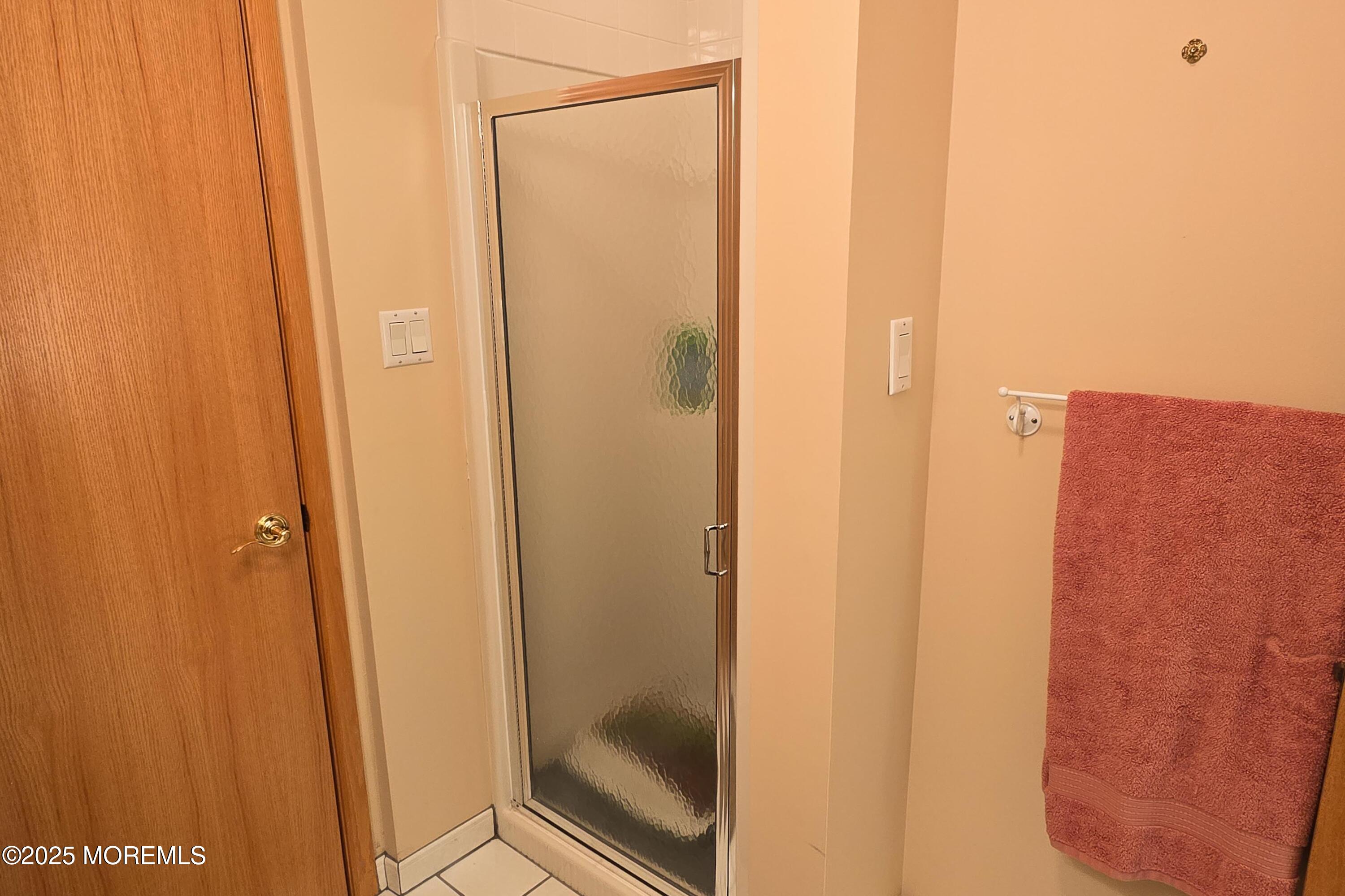 495 Boca Raton Drive Lavallette, NJ 08735 - Photo 26 of 48 a bathroom with a glass shower door