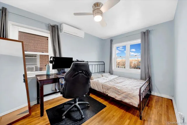 a bedroom that has a bed and a desk