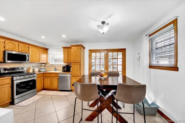 a dining room with furniture a window and wooden floor