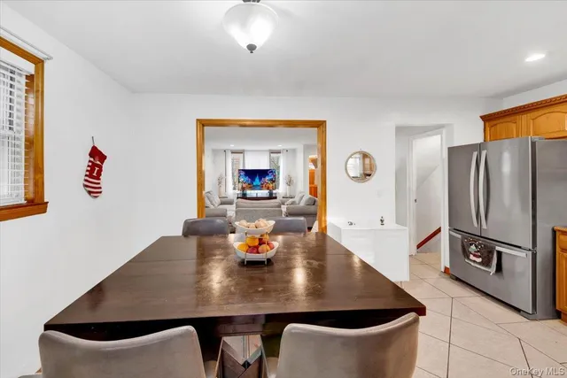 a view of a dining room with a table and chairs
