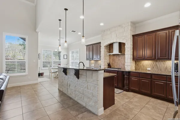 a large kitchen with cabinets and stainless steel appliances