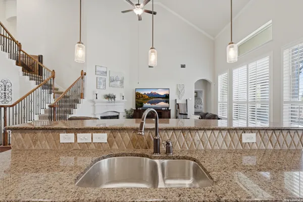 a kitchen with stainless steel appliances granite countertop a kitchen island a large counter top a stove and a sink