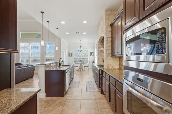 a kitchen with stainless steel appliances granite countertop a sink and cabinets